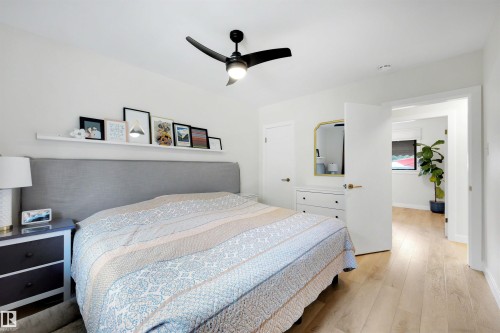 Bright interior with light wood-finish flooring - 10732 129 Street Nw, Edmonton, AB - Indoor Photo Showing Bedroom