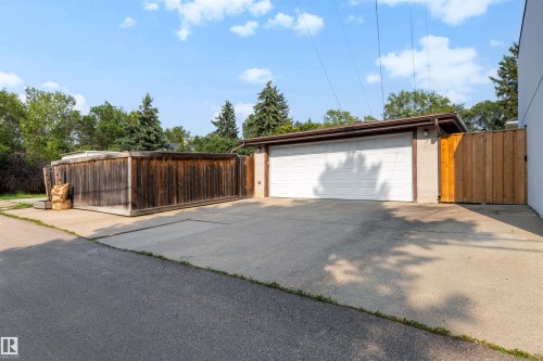 Detached garage with a white overhead door and a brown fascia - 10732 129 Street Nw, Edmonton, AB - Outdoor