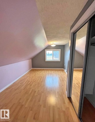 Laundry area featuring integrated cabinetry, a built-in countertop, and lino flooring situated on the main floor. - 3003 Park Avenue, Mallaig, AB - Indoor Photo Showing Laundry Room