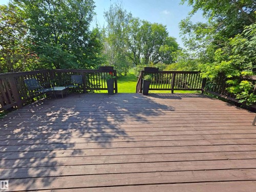 Expansive brown wood deck featuring direct access through double glass patio doors - 3003 Park Avenue, Mallaig, AB - Outdoor With Deck Patio Veranda With Exterior