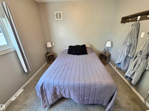 Carpeted room featuring neutral wall tones, main floor bedroom - 3003 Park Avenue, Mallaig, AB - Indoor Photo Showing Bedroom