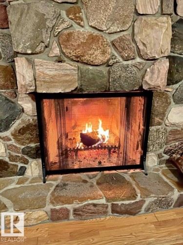 Stone fireplace - 3003 Park Avenue, Mallaig, AB - Indoor Photo Showing Other Room