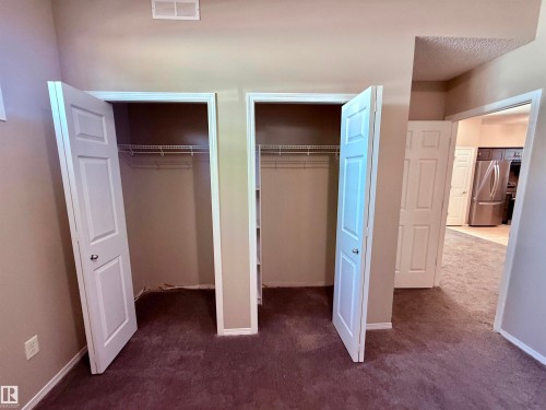 Bedroom with neutral wall paint and plush carpet flooring - 122 142 Selkirk Place, Leduc, AB - Indoor
