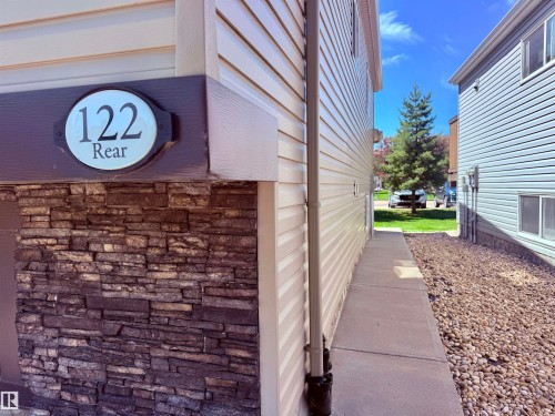 Exterior stone veneer accenting horizontal siding - 122 142 Selkirk Place, Leduc, AB - Outdoor