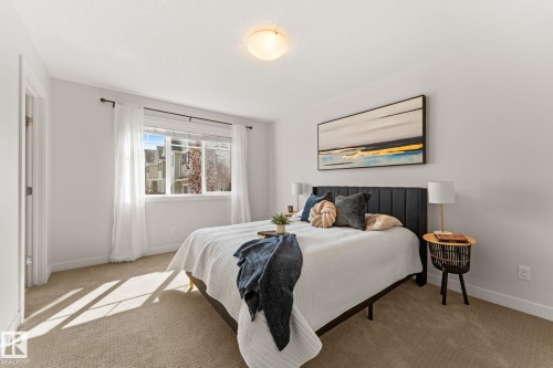 Carpeted room with a multi-pane window and a flush-mount ceiling light - #18 7289 South Terwillegar Dr Nw, Edmonton, AB - Indoor Photo Showing Bedroom