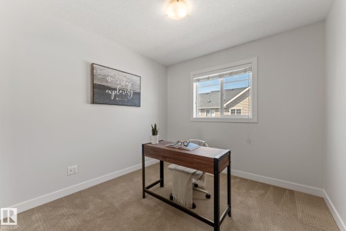 Light-filled room featuring neutral wall paint, white trim, and textured carpeting - #18 7289 South Terwillegar Dr Nw, Edmonton, AB - Indoor Photo Showing Office