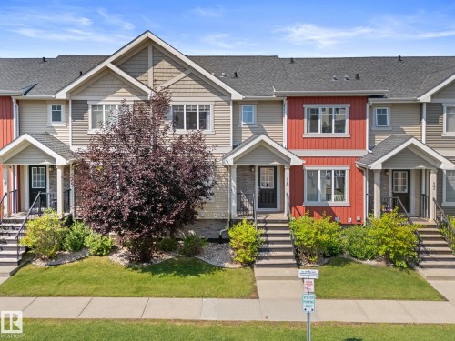 Multi-level townhome featuring a pitched shingle roof, siding facade, and front porch entryways - #18 7289 South Terwillegar Dr Nw, Edmonton, AB - Outdoor With Facade