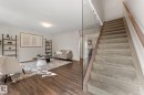 Carpeted staircase with glass panel railing and wood handrail - #18 7289 South Terwillegar Dr Nw, Edmonton, AB  - Indoor Photo Showing Other Room 