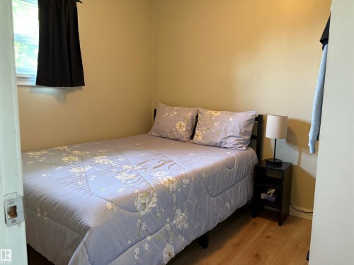 Compact room featuring light-toned walls and wood-finish flooring - 4901 53 Avenue, Elk Point, AB - Indoor Photo Showing Bedroom