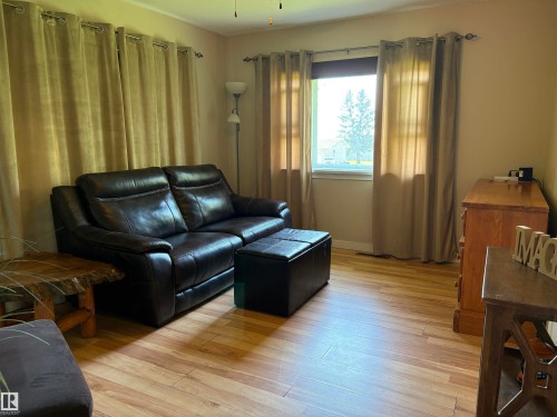 Room featuring wood-finish flooring, a window, and neutral wall tones - 4901 53 Avenue, Elk Point, AB - Indoor Photo Showing Living Room