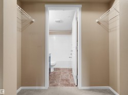 Carpeted entryway featuring two wire shelving units - 