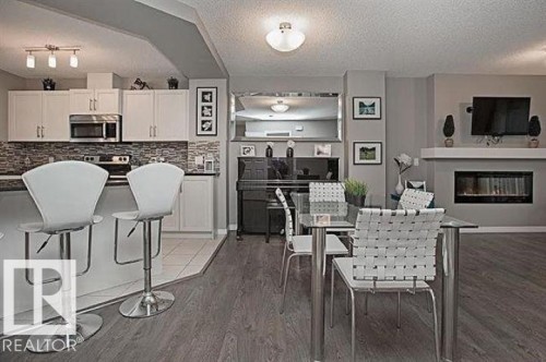 #95 4050 Savaryn Dr Sw, Edmonton, AB - Indoor Photo Showing Dining Room With Fireplace