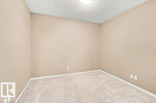 Neutral-toned walls complement plush carpeting throughout this versatile room - #119 111 Watt Cm Sw, Edmonton, AB - Indoor Photo Showing Other Room