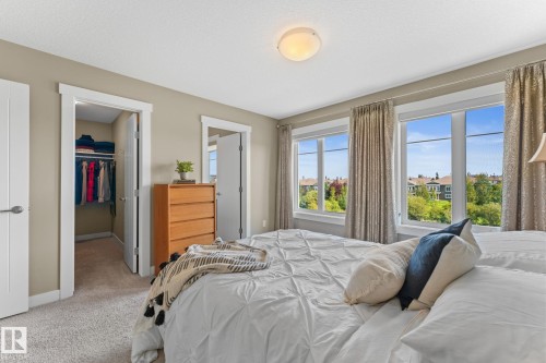 Bedroom featuring a walk-in closet with built-in shelving and hanging rods - 3413 Cameron Heights Cove Nw, Edmonton, AB - Indoor Photo Showing Bedroom