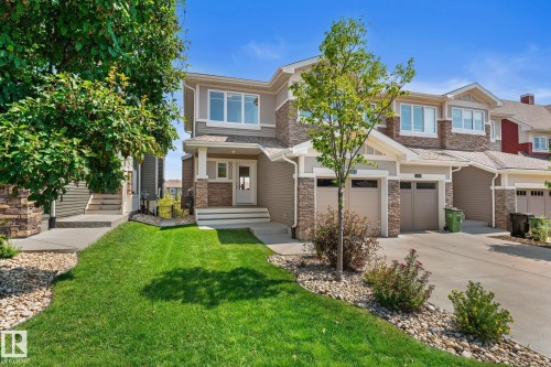 Two-story townhome featuring stone and siding exterior accents - 3413 Cameron Heights Cove Nw, Edmonton, AB - Outdoor With Facade