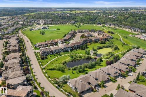 Aerial perspective showcasing a residential community with abundant green spaces - 3413 Cameron Heights Cove Nw, Edmonton, AB - Outdoor With View