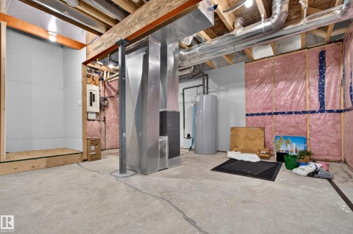Unfinished basement featuring exposed wood joists, concrete flooring, and visible ductwork - 1534 Plum Circle Circle Sw, Edmonton, AB - Indoor Photo Showing Basement