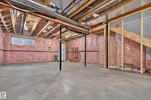 Unfinished basement space featuring exposed wood joists and concrete flooring - 1534 Plum Circle Circle Sw, Edmonton, AB - Indoor Photo Showing Basement