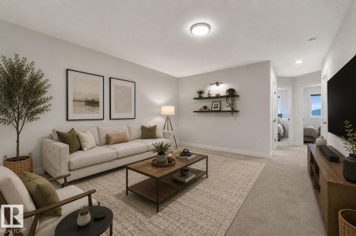 Carpeted living area featuring a neutral color palette, recessed lighting, and wall-mounted shelving - 1534 Plum Circle Circle Sw, Edmonton, AB - Indoor Photo Showing Living Room
