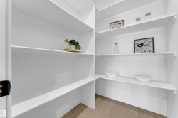Expansive pantry with bright white shelving - 