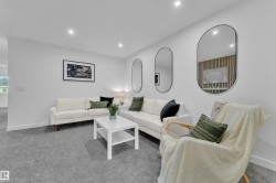 Spacious room featuring neutral carpeting, recessed ceiling lighting, and a white baseboard trim - 