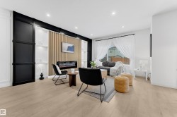 Contemporary living area featuring wood-finish flooring, a built-in electric fireplace, and recessed ceiling lighting - 