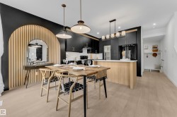 Open-concept dining area featuring light wood-finish flooring - 