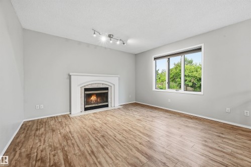 219 Buchanan Close Nw, Edmonton, AB - Indoor Photo Showing Living Room With Fireplace
