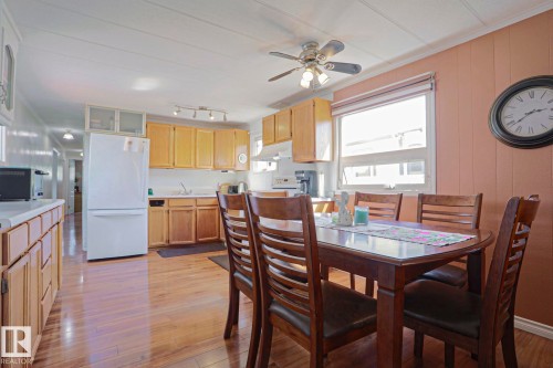 Kitchen and dining area featuring wood-finish flooring, light wood cabinetry, a ceiling fan, a window, and track lighting - 137 Lee Ridge Road Nw, Edmonton, AB - Indoor