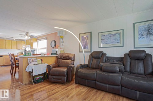 Wood-finish flooring throughout, with a partial wall separating living and kitchen areas - 137 Lee Ridge Road Nw, Edmonton, AB - Indoor Photo Showing Living Room