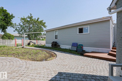 Rear exterior featuring horizontal siding, a white-trimmed window, and a wood deck with steps - 137 Lee Ridge Road Nw, Edmonton, AB - Outdoor With Exterior