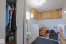 Utility space featuring light wood-finish cabinetry, a flush-mount ceiling light fixture, and a window with horizontal blinds - 137 Lee Ridge Road Nw, Edmonton, AB  - Indoor 