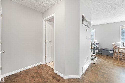 Light gray walls with wood-finish flooring - #40 1030 Chappelle Bv Sw, Edmonton, AB - Indoor Photo Showing Other Room