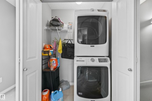 Dedicated laundry closet with bi-fold doors - #40 1030 Chappelle Bv Sw, Edmonton, AB - Indoor Photo Showing Laundry Room