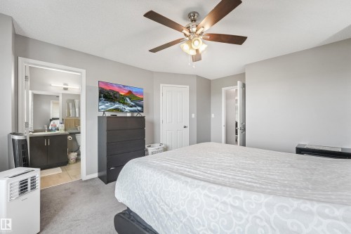 Spacious bedroom featuring neutral gray walls and gray carpeting - #40 1030 Chappelle Bv Sw, Edmonton, AB - Indoor Photo Showing Bedroom