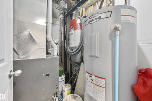 Dedicated utility space featuring a water heater and furnace unit - #40 1030 Chappelle Bv Sw, Edmonton, AB - Indoor Photo Showing Basement