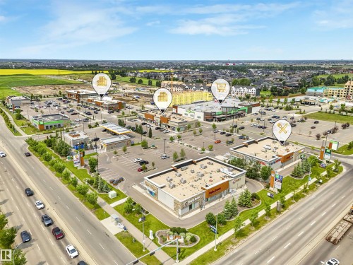 Aerial perspective showcasing a commercial development with multiple retail buildings and extensive parking areas - #40 1030 Chappelle Bv Sw, Edmonton, AB - Outdoor With View