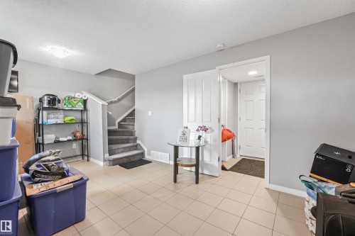 Tile flooring with light grey walls - #40 1030 Chappelle Bv Sw, Edmonton, AB - Indoor Photo Showing Other Room