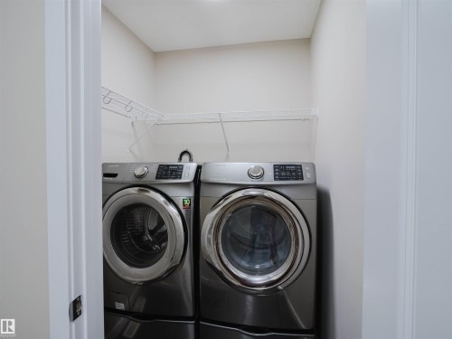 Dedicated laundry closet featuring a white wire shelving system and light neutral wall tones - 5407 14 Avenue Sw, Edmonton, AB - Indoor Photo Showing Laundry Room