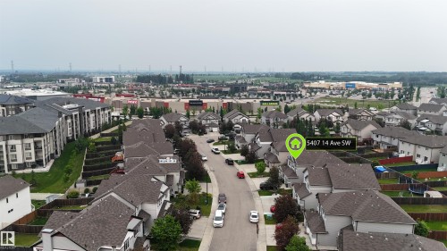 Aerial view showcasing a residential street with multiple detached homes and apartment buildings - 5407 14 Avenue Sw, Edmonton, AB - Outdoor With View