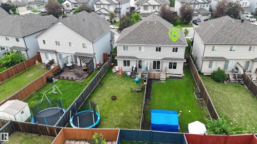 Manicured backyard featuring a wooden deck with railing, a patio with a pergola, and a private wooden fence - 5407 14 Avenue Sw, Edmonton, AB - Outdoor With Deck Patio Veranda