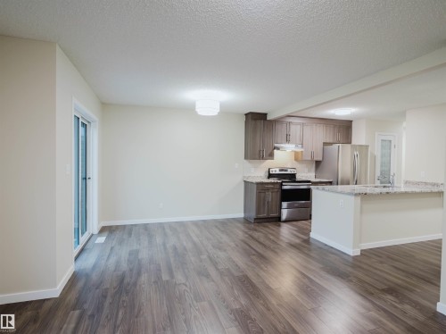 Open-concept living space featuring wood-finish flooring - 5407 14 Avenue Sw, Edmonton, AB - Indoor Photo Showing Kitchen