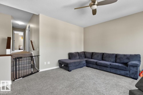 Spacious carpeted room featuring neutral wall tones and a ceiling fan - 109 Selkirk Place, Leduc, AB - Indoor Photo Showing Living Room