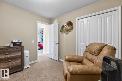 Carpeted room with neutral wall tones and white baseboards - 109 Selkirk Place, Leduc, AB - Indoor