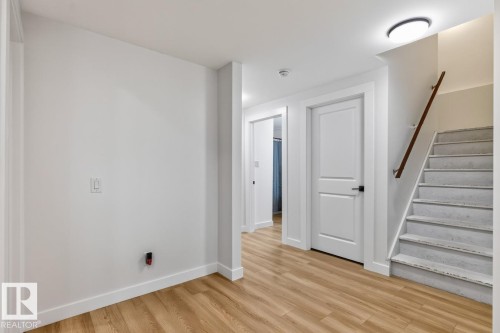 Light wood-finish flooring complements the crisp white walls and trim - 109 Selkirk Place, Leduc, AB - Indoor Photo Showing Other Room