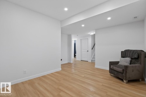 Spacious interior featuring light wood-finish flooring, recessed ceiling lighting, and crisp white walls - 109 Selkirk Place, Leduc, AB - Indoor Photo Showing Other Room