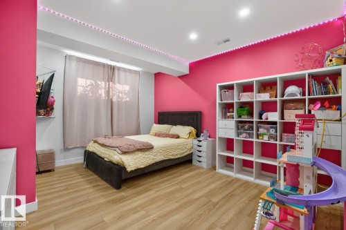 Spacious room featuring wood-finish flooring, a large window with privacy coverings, and recessed ceiling lighting - 109 Selkirk Place, Leduc, AB - Indoor Photo Showing Bedroom