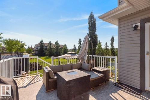 Exterior deck with concrete surfacing, white railing, and grey horizontal siding - 109 Selkirk Place, Leduc, AB - Outdoor With Deck Patio Veranda With Exterior