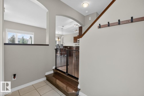 Entryway featuring tile flooring, wood-finish stair treads, and a wood-finish handrail - 109 Selkirk Place, Leduc, AB - Indoor Photo Showing Other Room