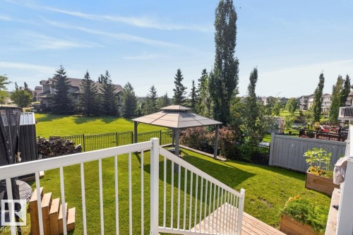 Expansive backyard featuring a central gazebo, manicured lawn, and mature trees - 109 Selkirk Place, Leduc, AB - Outdoor With Deck Patio Veranda With Backyard